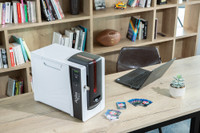 Evolis Agilia ID card printer in use on an office desk