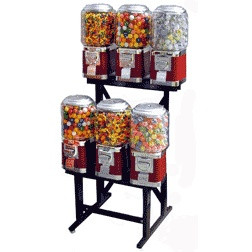 Six-machine vending rack, turned slightly left, showing all machines in two neat rows on a black steel stand.