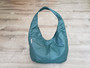 Green leather bag in hobo style
