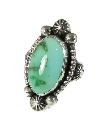 An elegant silver Royston Rings band showcases a vibrant green turquoise stone.