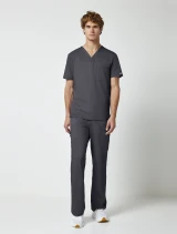 Full-length model view of Cherokee Workwear Revolution Men's Tuckable V-Neck Scrub Top WW690 in Pewter
