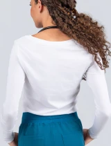 Waist high back-side image of a female nurse wearing a Spirit Scrubs women's long-sleeve underscrub tee in white (Style PL704).