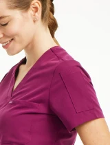 Sleeve view of the Spirit Scrubs women's tuck-in scrub top #UOT113 in wine