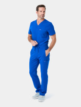 Full body view of the Spirit Scrubs men's V-neck medical scrub top in royal UOT333 tucked into the scrub pant UOB609 in royal.