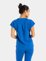 Back view of model wearing Spirit Scrubs royal blue dolman-sleeve scrub top (Style UOT115).