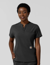A female healthcare worker wearing the Carhartt women's chest pocket scrub top C13810 in black