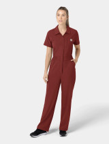 A top and pant full body view of a healthcare worker wearing the Carhartt womens scrub jumpsuit C21110 in amber terrain