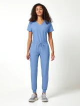 Female model wearing a Cherokee Ultra scrub top tucked into the Cherokee Ultra women's jogger scrub pant in ciel blue (Style CK00034A)