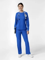 Full-length model view of WINK Boundless Women's Crew Neck Classic Long Sleeve Scrub Tee 6551 in Royal