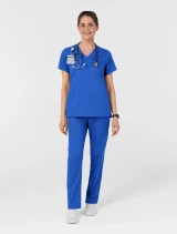 Full-length model view of WINK Boundless Women's Slip-In Pockets V-Neck Scrub Top 6751 in Royal