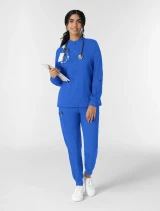 Full-length model view of WINK Boundless Women's Zip-Front Warm-Up Scrub Jacket 8151 in Royal