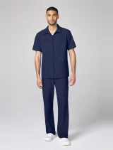 Full-length model view of Cherokee Workwear Originals Ultra Men's Full Zip Scrub Jacket CK00027 in Navy