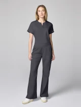 Full-length model view of Cherokee Workwear Revolution Women's Mid Rise Flare Cargo Scrub Pant CK00039 in Pewter