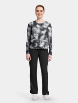 Full-length model view of Healing Hands Knits and Tees Women's Melissa Tee Scrub Top HH816 in Tie Dye Black