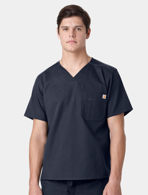 A front view from the waist up of a healthcare worker wearing the Carhartt mens scrub top C15108 in navy
