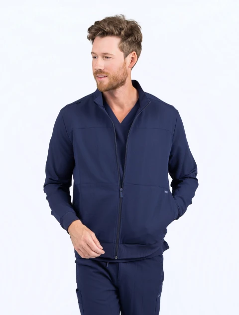 Waist high view of a man wearing the Spirit Scrubs zip-front scrub jacket in navy blue (Style #UOJ809)