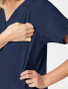Chest pocket view of the women's Wink W123 maternity scrub top #4555 in navy.