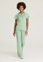 Full model view of the Skechers Ripstop women's zip-neck tuckable scrub top skt284 in field green