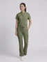 Full-length model view of Healing Hands Quest Women's 6-Pocket Flare Leg Scrub Pant HH150 in Olive