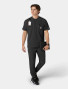 A top and pant full body view of a healthcare worker wearing the Carhartt mens scrub top C16310 in black