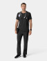 A top and pant full body view of a healthcare worker wearing the Carhartt mens scrub top C16510 in black