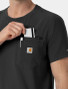 A close up view of the chest pocket on the Carhartt mens scrub top C16510 in black
