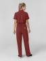 The back of a healthcare worker wearing the Carhartt womens scrub jumpsuit C21110 in amber terrain