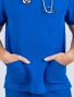 Zoomed image of the front pockets with a male's hands in them  of the Spirit Scrubs men's 3-pocket V-neck scrub top in royal blue (style #UOT336)