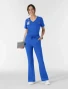 Full-length model view of WINK Boundless Women's Flare Leg Cargo Scrub Pant 5551 in Royal