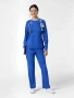 Full-length model view of WINK Boundless Women's Crew Neck Classic Long Sleeve Scrub Tee 6551 in Royal