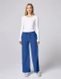 Full-length model view of Med Couture Insight Women's Wide Leg Pintuck Scrub Pant MC00009 in Royal