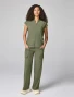 Full-length model view of Healing Hands Quest Women's Mandarin Collar Scrub Top HH757 in Olive