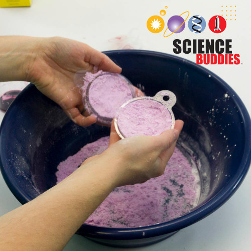 Bath Bomb Science Kit: hands pressing pink bath bomb mixture into a mold