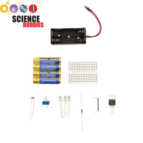 Layout of the Science Buddies Night-Light kit including the circuit board, assorted lights, and batteries.