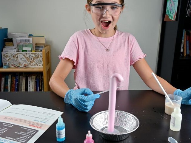 Student creating Elephant Toothpaste experiment with Fizz Foam Fire Kit