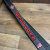 Black radio strap with red paint and white stitching