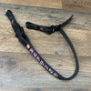 Black chin strap with red paint, white outline and blue stitching