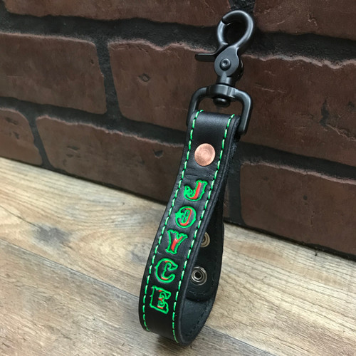 Black glove strap with our thin red line flag, green outline and green stitching