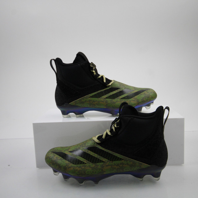 green and black football cleats