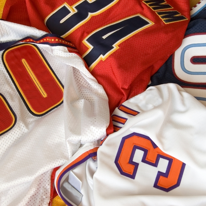 A white, long sleeve baseball style t-shirt with yellow sleeves on a white background