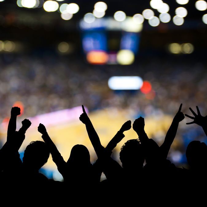 A tournament crowd cheering their team on during an NCAA basketball game.