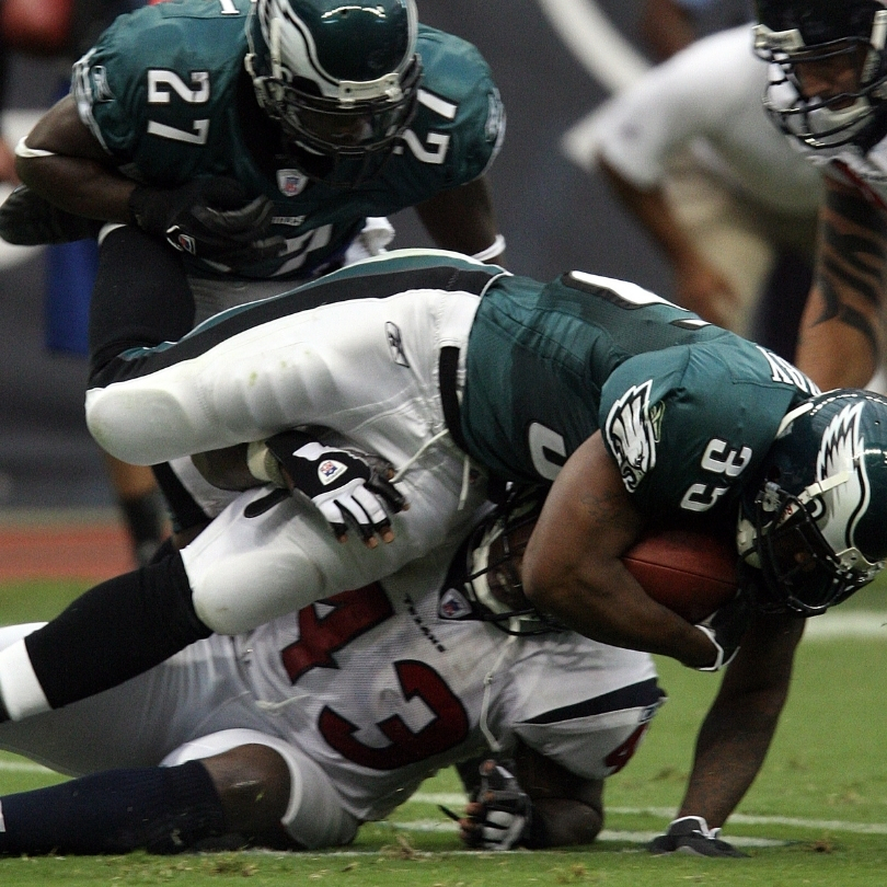 An NFL game, mid play, between the Philadelphia Eagles and the  Houston Texans