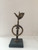 Alain Moreira #6729. Untitled, 2012. Bronze and marble. 4 x 4 x 10 inches