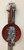 Carlos César Román,                                         "Yo soy mi luz,"2015. Mixed media: found objects, frying pan on wood.        21" x 9"       #6123