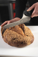 offset DuoGlide bread slicer slicing through a loaf of bread