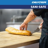 SANI-SAFE® Scalloped Offset Sandwich Knife cutting bread on counter