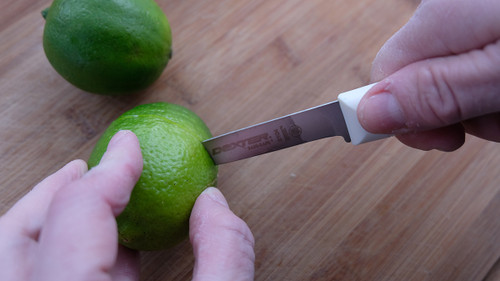 paring knife cutting into a lime