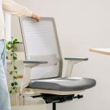 Weisser Ergonomischer Bürostuhl Active an einem Bürotisch in einem modernen Homeoffice