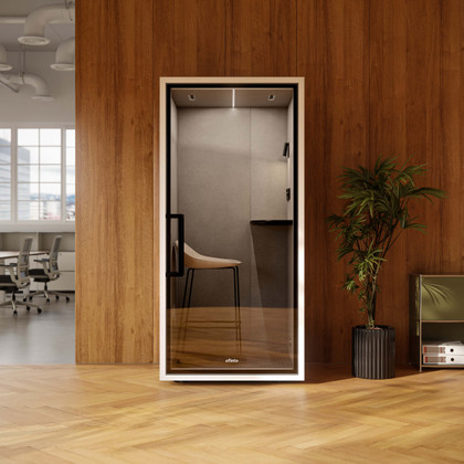 Focus Call phone booth with furniture in a modern office featuring wood paneling, hardwood floors, and a plant