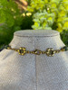 Decorative floral clasp detail from the Forest Bloom handcrafted gemstone necklace featuring antique gold-tone flower connectors and lobster clasp by Stone & Story Jewelry.